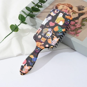 Close-up of hairbrush back featuring cute kitten patterns and floral illustrations