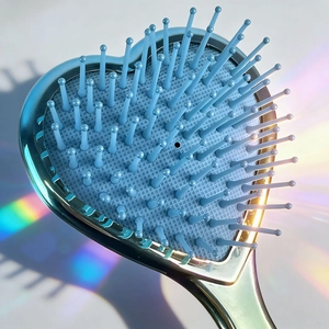 Metallic blue heart-shaped massage hairbrush with rainbow light effects and soft bristles