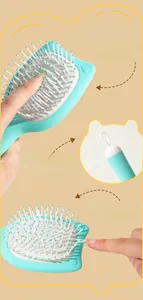 Close-up of flexible air cushion and soft massage bristles on the mint cat ear comb