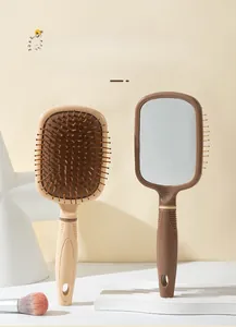 Detail of the 2-in-1 massage comb and mirror set with ergonomic non-slip handle