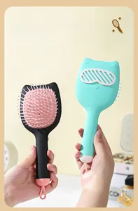 Close-up of cute cartoon cat hairbrushes featuring soft air cushions and handy hanging loops