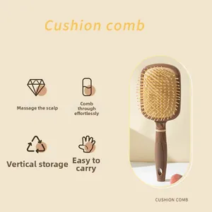 Detail of cushion hairbrush with massage bristles, non-slip handle and hanging hole