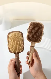 Detailed macro view of wide-tooth scalp massage hairbrushes in brown and tan colors