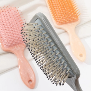 Marble pattern air cushion hair brush set in grey, pink, and orange for scalp massage