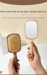Dual-sided hair brush featuring massage air cushion and integrated mirror in beige