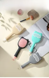 Close-up of cat-shaped massage air cushion hairbrushes in various pastel colors