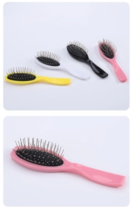 Detail of colorful mini hairbrushes with steel needles and ergonomic plastic handles