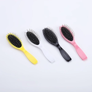 Set of four colorful oval hair brushes with steel pins and black air cushions on white background