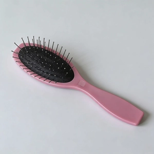 Brosse à cheveux rose à coussin d'air avec picots en acier pour massage du cuir chevelu