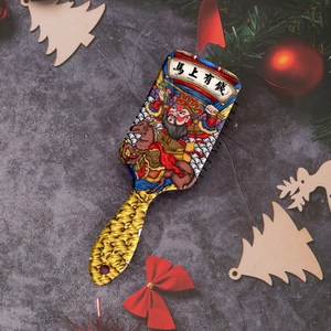Detail view of rectangular cushion hairbrush featuring colorful Chinese style horse artwork