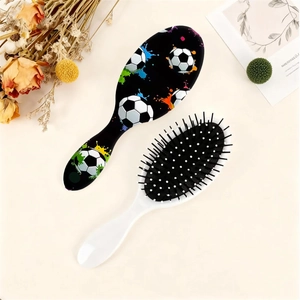 Soccer pattern air cushion massage hairbrush set with ergonomic handle on neutral background