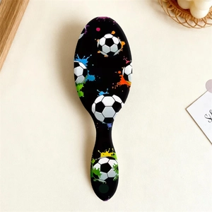 Close-up of air cushion hairbrush with soccer print and colorful splatter art