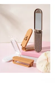 Detail of portable folding hairbrush with mirror featuring 3D cute cartoon bears