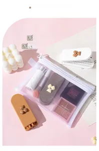 Detail of portable folding mirror with comb and mesh bag on a pink aesthetic background