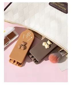 Detail of portable bear-themed folding mirror and comb set inside a makeup bag