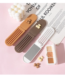 Detail view of foldable rectangular makeup mirror with comb and 3D bear decoration