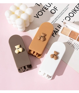 Three rectangular hair clips with matte bears and miu text on a pink aesthetic background