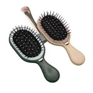 Portable air cushion massage hairbrushes in green and beige with geometric diamond texture