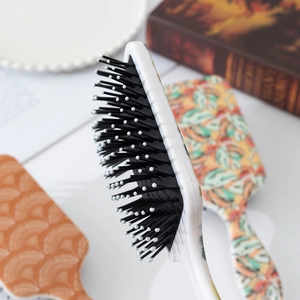 Colorful air cushion massage hairbrushes with UV printed tropical patterns and white frames