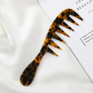 Macro shot of wide-tooth cellulose acetate hair comb with classic tortoiseshell pattern