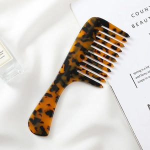 Minimalist marble pattern acetate wide tooth comb on elegant white silk background