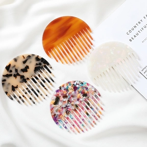 Set of four stylish marble pattern acetate hair combs with elegant tortoiseshell and pearl finishes