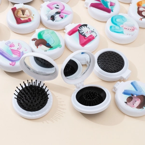 Macro detail of portable folding hairbrush with cartoon animals and makeup mirror