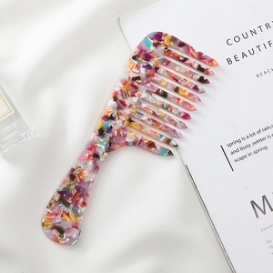 Wide-tooth acetate hair comb with a colorful marble texture and ergonomic handle design
