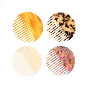 Set of four round marble pattern acetate hair combs in amber and tortoiseshell finishes