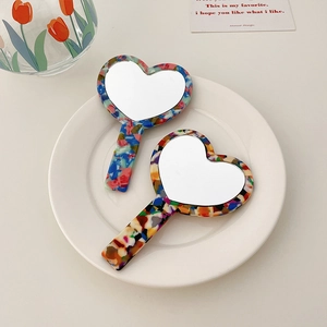 Elegant heart-shaped acetate handheld vanity mirrors with colorful floral patterns
