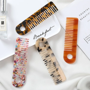 Chic acetate hair combs with marble and tortoiseshell patterns in a luxury setting