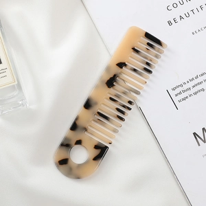 Elegant tortoiseshell acetate hair comb with wide teeth and a convenient hanging hole