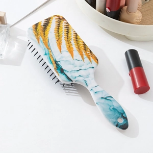 Detail view of marble pattern cushion hairbrush on white desk with beauty accessories