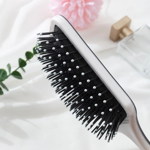 Silver square paddle hairbrush with black air cushion and anti-static massage bristles