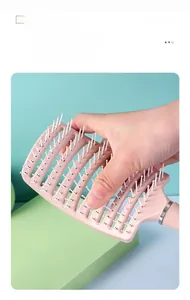 Macro detail of pink curved vent brush showing rounded massage pins and hollow structure