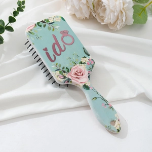 Detailed view of floral pattern air cushion comb on elegant white satin background
