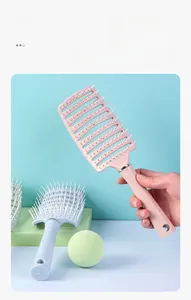 Close-up of curved vent hairbrush with ergonomic handle and hollow airflow design