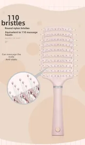 Detailed view of pink vented hairbrush with massage bristles and scalp-contoured design