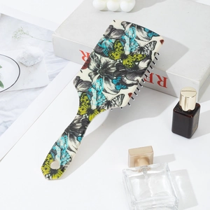 Detailed view of vintage air cushion hairbrush with sunflower and butterfly prints