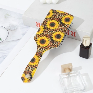 Close-up of hair brush showing sunflower and leopard print pattern with soft massage bristles
