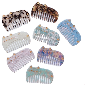 Eight colorful acetate cat-shaped wide-tooth hair combs featuring various marble patterns