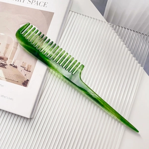 Macro detail of emerald marble acetate wide tooth tail comb for hair styling and parting