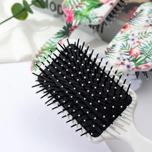 Floral air cushion hairbrush with tropical flamingo print and massaging bristles