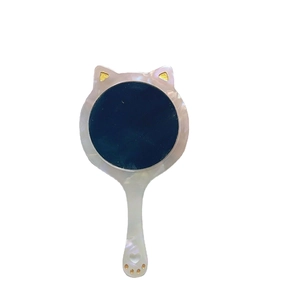 Cat-shaped handheld vanity mirror with pearlescent finish and gold ear accents