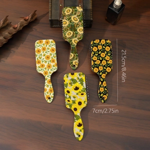 Four sunflowers print air cushion hair brushes set on vintage wood background