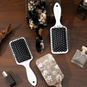 Vintage floral print cushion massage hairbrush set on elegant wooden background