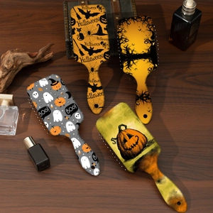 Detailed view of four Halloween massage hairbrushes with festive pumpkin and ghost prints