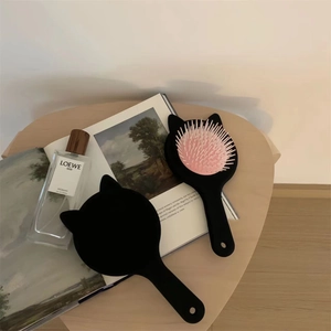 Cute cat-ear air cushion hairbrush in black and pink with heart-shaped wooden tray