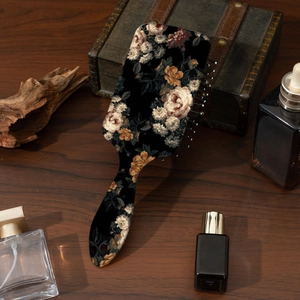 Detail of vintage floral print hairbrush on a wooden vanity with professional lighting