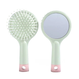 Detail of macaron green cushion hairbrush with built-in makeup mirror and soft bristles